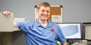 Happy Employee Standing Inside Shickel Office